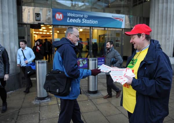 John Stewart, Sec RMT Leeds Branch hands out leaflets at Leeds City Station.