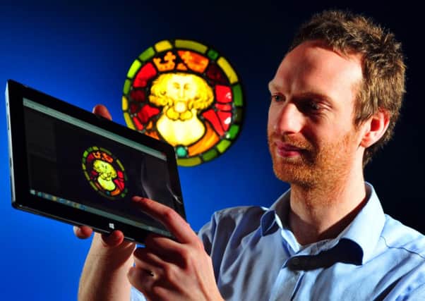 Martin Fell, digital team leader at York Museums Trust with a 14C stained glass roundall in the Yorkshire Museum, one of thousands of artifacts which have been photographed and available to view on the internet. 
Picture: Tony Johnson