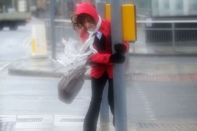 A pedestrian braves stormy conditions at Bridgewater Place in 2013.