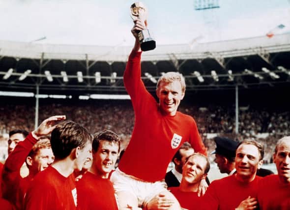 MAGIC MEMORIES: Captain Bobby Moore, with his England team-mates, including Geoff Hurst, third from left, after winning the World Cup in 1966. Picture: AP