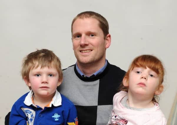 Duncan Brownnutt with his children Caleb, four, and Ellie Mae, six, ahead of his fundraising cycle ride. Picture by Steve Riding.