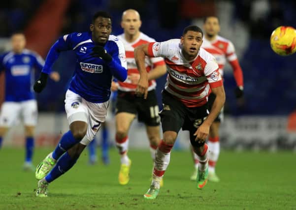 Oldham Athletic's Amari Morgan-Smith (left) and Doncaster Rover's Kyle Bennett battle for the ball.