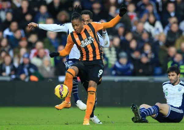 West Bromwich Albion's Joleon Lescott and Hull City's Abel Hernandez (front) battle for the ball.