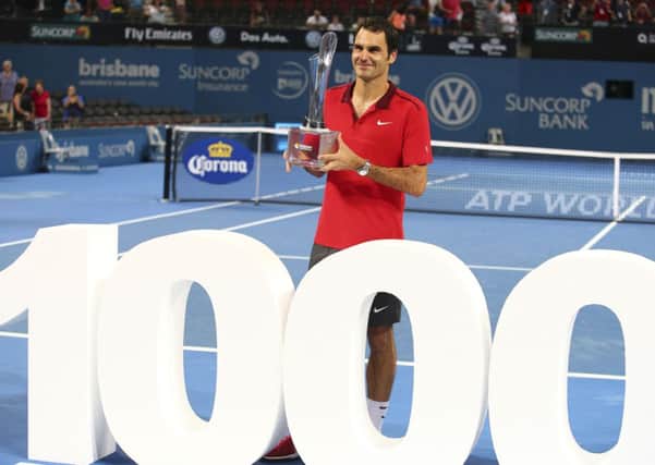 LOTS: Roger Federer of Switzerland holds the winner's trophy and pose for photos after he won his 1000th career title in the men's final of  the Brisbane International. Picture: AP/Tertius Pickard.