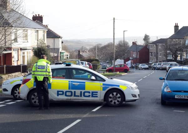 Police seal off Worrall Road after the unexplained death of a woman there on Sunday morning