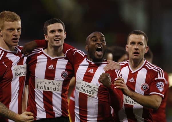 Jamal Campbell-Ryce celebrates United's second goal with team-mates.