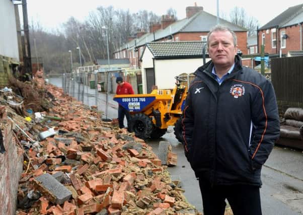 Castleford Tigers' chief executive Steve Gill inspects the damage after high winds ripped through their Wheldon Road ground, causing walls to collapse by the Princess Street stand (Picture: Diane Allen).