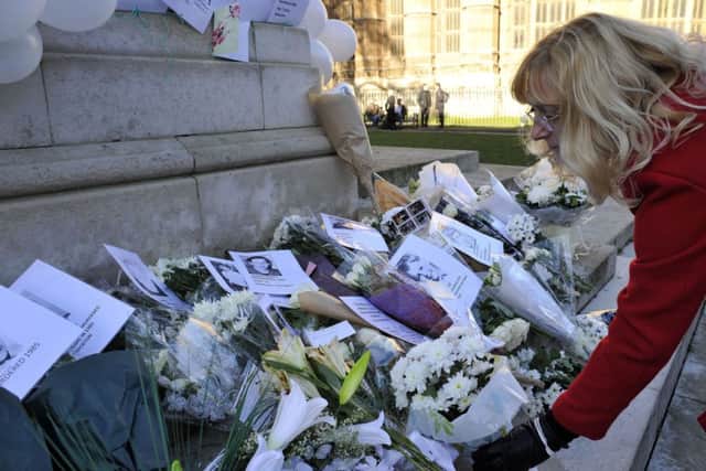 Tributes at Old Palace Yard in Westminster, during an event in commemoration of victims and survivors of child abuse, addressed by Rotherham MP Sarah Champion (below).