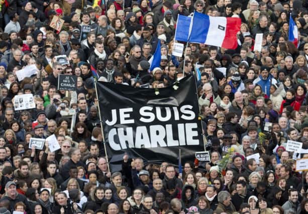 Thousands of people gather at Republique square in Paris, France, Sunday, Jan. 11, 2015.  Thousands of people began filling Frances iconic Republique plaza, and world leaders converged on Paris in a rally of defiance and sorrow on Sunday to honor the 17 victims of three days of bloodshed that left France on alert for more violence. (AP Photo/Peter Dejong)