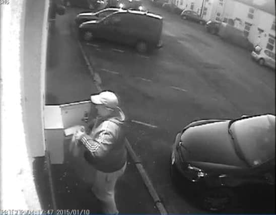 CCTV shows a man stealing a defibrillator from a wall in Bridlington, East Yorkshire.  Pictures: Ross Parry Agency