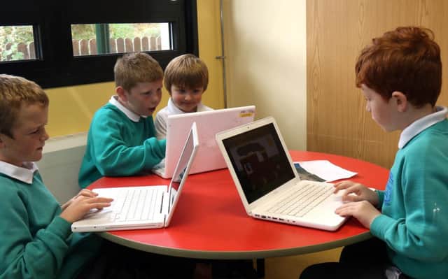 Primary school pupils enjoying a computer lesson