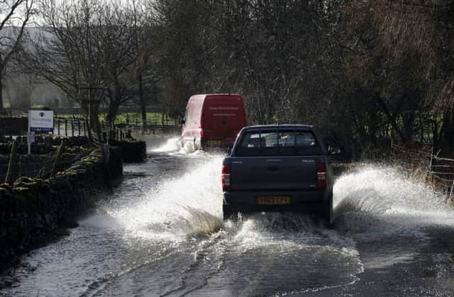 Water woes: Drivers battle through flooded roads in the Yorkshire Dales.