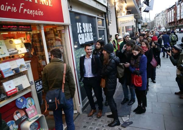 The queue outside Librairie La Page bookshop in south Kensington, London, where people are waiting to buy a copy of French satirical magazine Charlie Hebdo.