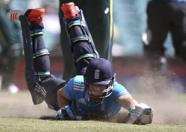 DOWN BUT NOT OUT: England's Jos Butler dives to make his ground in Sydney. England still lost. AP/Rick Rycroft.