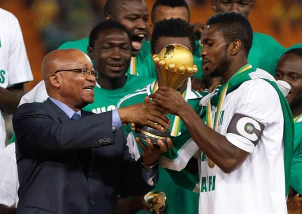 South Africa's President Jacob Zuma, left, hands the trophy to Nigeria's team captain Joseph Yobo after they defeated Burkina Faso in the final to win the 2013 African Cup of Nations.
