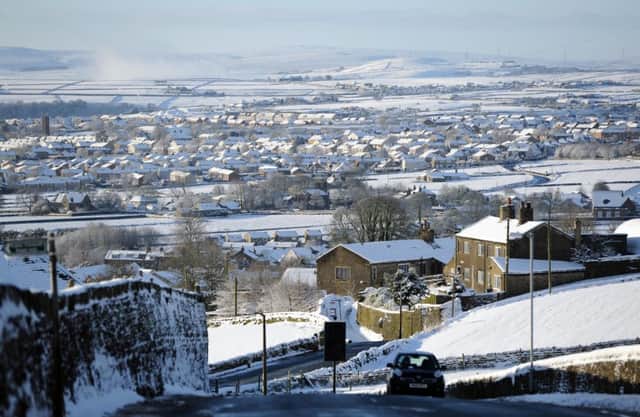 The Pennines form a backdrop to the suburbs of Halifax in a wintry scene following the weekend's snowfall.