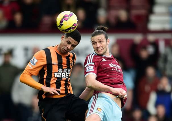 Hull City's Jake Livermore and West Ham United's Andy Carroll battles for the ball.