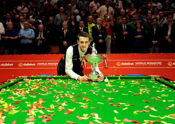 Mark Selby celebrates after winning the final of the Dafabet World Snooker Championships at The Crucible, Sheffield. The world championships will continue at its traditional home until at least 2017.