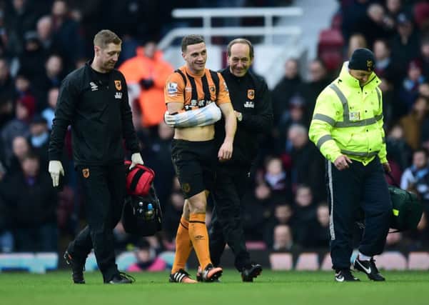 OUT: Hull City's James Chester is substituted off after suffering a dislocated shoulder during yesterday's 3-0 defeat at West Ham United.