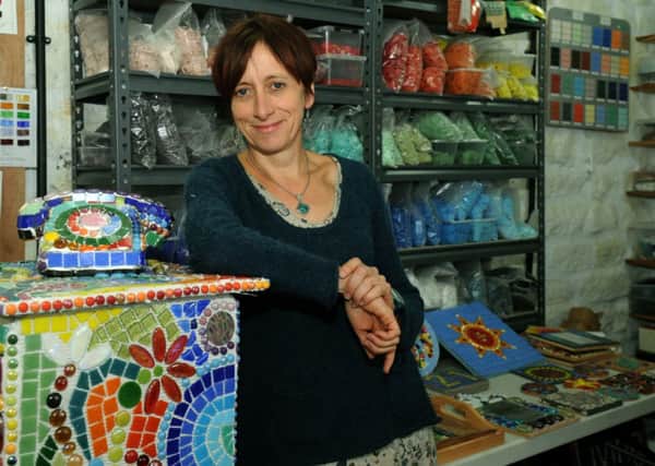 Mosaic artist Frances Taylor  in her studio in Otley. Below: With student Clare Harris making a mosaic dog, and one of Frances's school mosaics.