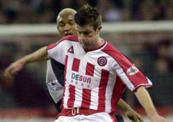 Sheffield United's two-goal first leg hero in 2003, Michael Tonge, shields the ball from Liverpools El Hadji Diouf at Bramall Lane (Picture: Gerard Binks).