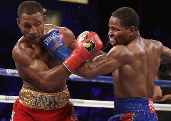 Shawn Porter, right, and Kell Brook trade punches during their IBF welterweight title boxing bout in Carson, Calif. (AP Photo/Chris Carlson)