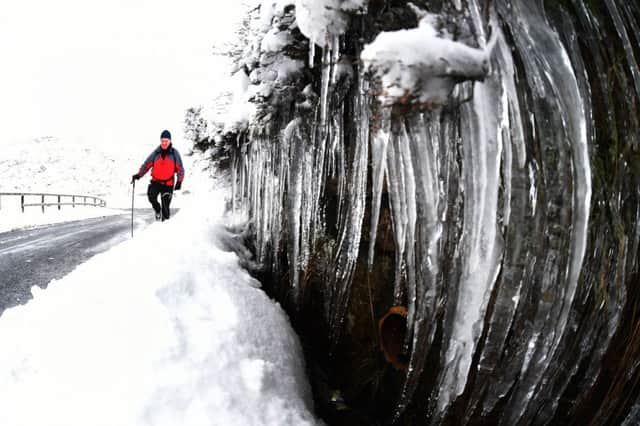 Bob Garnett, 75, from Riding Mill, walks in Northumberland as icicles form on the side of the road, as motorists were warned to take extra care on the roads in icy conditions as Britain froze on the coldest night of the winter so far. PRESS ASSOCIATION Photo. Picture date: Monday January 19, 2015. See PA story WEATHER Winter. Photo credit should read: Owen Humphreys/PA Wire