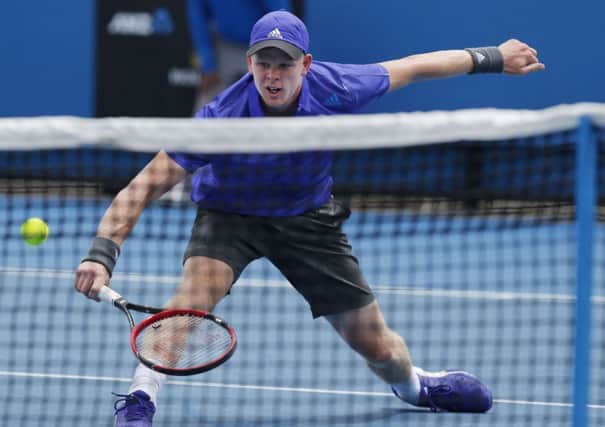Kyle Edmund of Britain attempts to volley to Steve Johnson of the U.S. during their first round match at the Australian Open tennis championship in Melbourne. (AP Photo/Shuji Kajiyama)