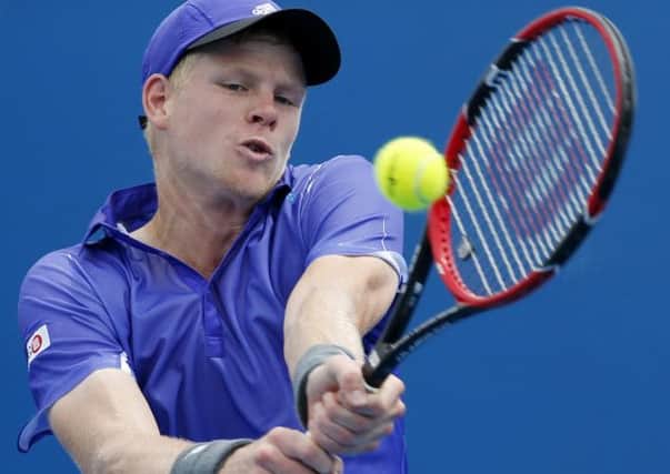 Kyle Edmund of Britain makes a backhand return to Steve Johnson of the U.S. during their first round match at the Australian Open tennis championship in Melbourne. (AP Photo/Shuji Kajiyama)