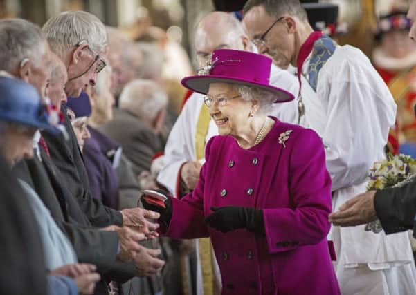 The Queen hands out Maundy money at Blackburn Cathedral during last year's service.