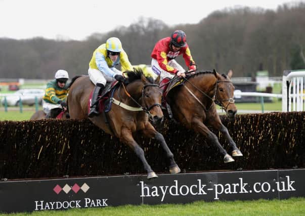 Wakanda and Danny Cook, left, win the CE Facilities Novices Chase  at Haydock. Picture: John Giles/PA