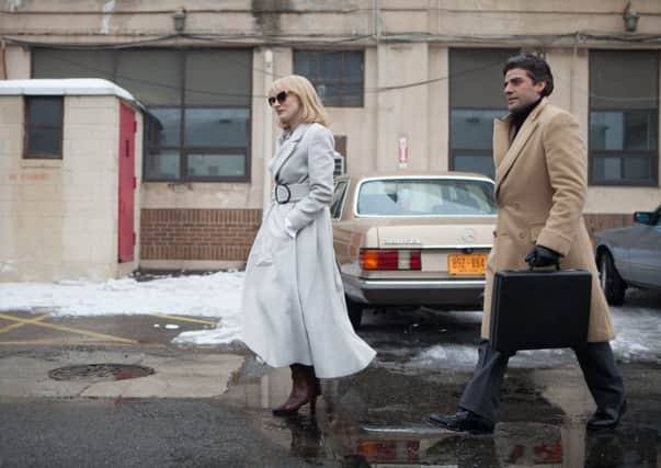 Jessica Chastain as Anna Morales and Oscar Isaac as Abel Morales.