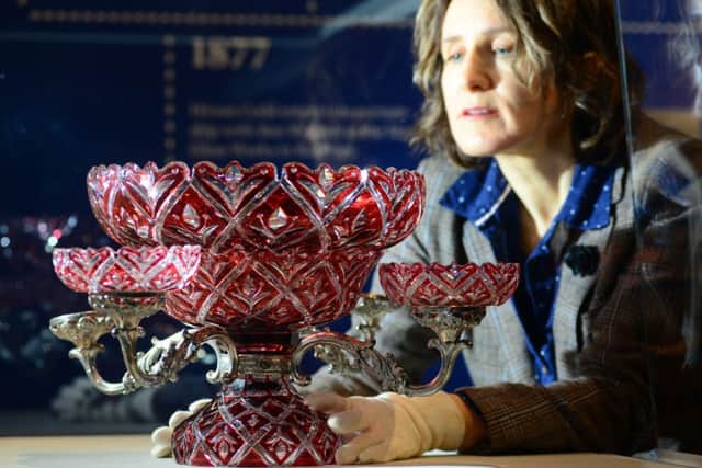 Exhibitions officer Alison Morton with a ruby epergne. Picture: Scott Merrylees
