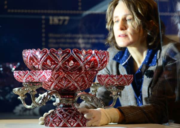 Exhibitions officer Alison Morton with a ruby epergne. Picture: Scott Merrylees