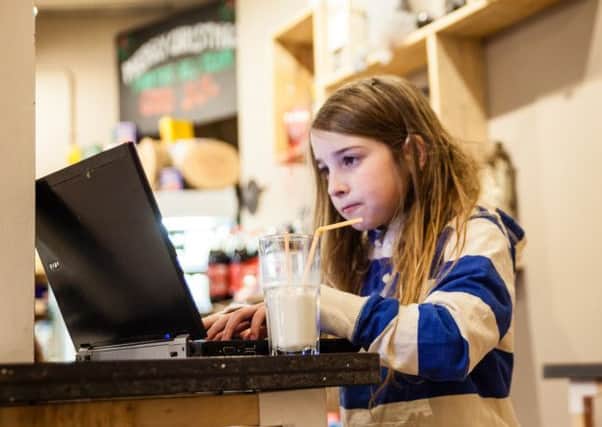 Seven-year-old Betsy Davies in a coffee shop taking part in an ethical hacking experiment to illustrate how easy it is to hack into unsecured public Wi-Fi hotspots.