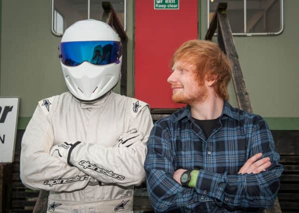 Ed Sheeran with The Stig during a visit to the Top gear track in Surrey where he took a spin as the Star In A Reasonably Priced Car. PRESS ASSOCIATION Photo. Issue date date: Thursday January 22, 2015. Although as a guitarist he is used to stamping on a few pedals, the hitmaker is still getting to grips with the footwork on a car as he still has no driving licence. See PA story SHOWBIZ TopGear. Photo credit should read: BBC/PA Wire  NOTE TO EDITORS: Not for use more than 21 days after issue. You may use this picture without charge only for the purpose of publicising or reporting on current BBC programming, personnel or other BBC output or activity within 21 days of issue. Any use after that time MUST be cleared through BBC Picture Publicity. Please credit the image to the BBC and any named photographer or independent programme maker, as described in the caption.