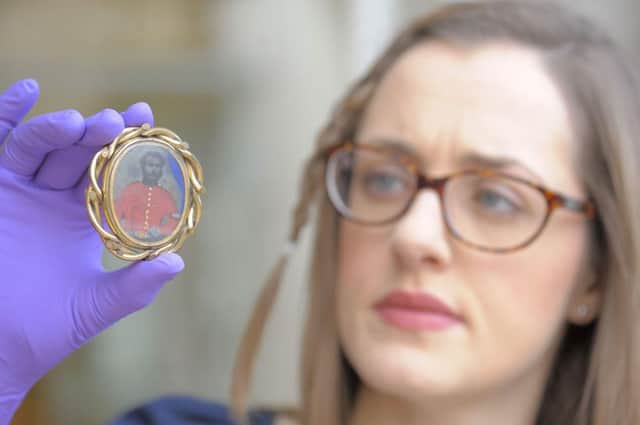Jennifer Dunne, Collections Manager for Scarborough Museums Trust, with a reversible Victorian love token brooch showing a man in army uniform on one side and civilian clothing on the other. Picture: Tony Bartholomew