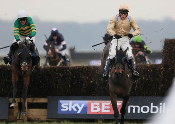 Champagne Rian, right, ridden by James Reveley, jumps the last fence to win the Skybet Home Of Price Boost Handicap Steeple Chase at Doncaster on Friday. Picture: Nigel French/PA.