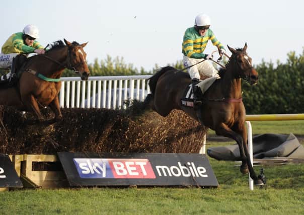If in Doubt ridden by Tony McCoy, right, jumps the final fence to win the Skybet Chase at Doncaster. Picture: John Giles/PA.
