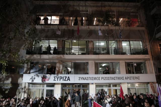 Supporters and media gather outside headquarters of Greece's Syriza left-wing main opposition party in Athens, Sunday, Jan. 25, 2015. Greek election officials say the anti-austerity Syriza party has won Sunday's vote, but it is too soon to say whether it has enough support to form a governing majority. (AP Photo/Lefteris Pitarakis)