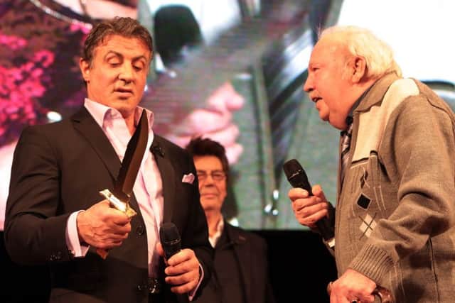 Sly Stallone is presented with a new Rambo knife by Reg Cooper. Pic: Glenn Ashley.