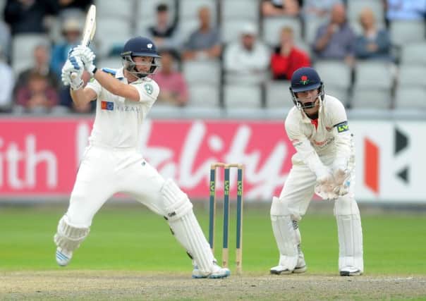 Adam Lyth hits a boundry on his way to his century for Yorkshire against Lancashire