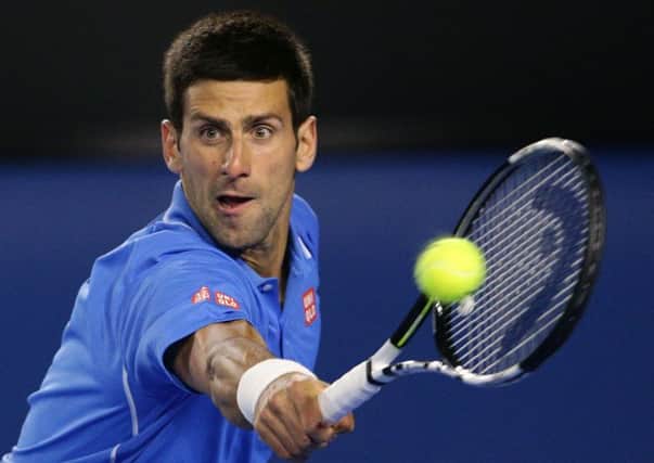 Novak Djokovic of Serbia makes a backhand return to Gilles Muller of Luxembourg during their fourth round match at the Australian Open