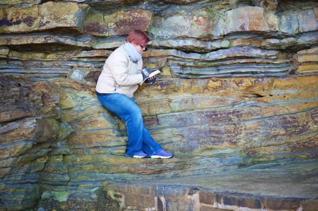 Artist Tina Mammoser exploring and sketching some of the geology to be found on the East Coast. Pictures: Tony Bartholomew