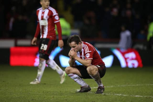 HIGHS AND LOWS: Sheffield Uniteds Jose Baxter shows his dismay, with two-goal hero Che Adams looking on behind, after the Blades were denied by Premier League Tottenham Hotspur last night. Picture: Martyn Harrison.