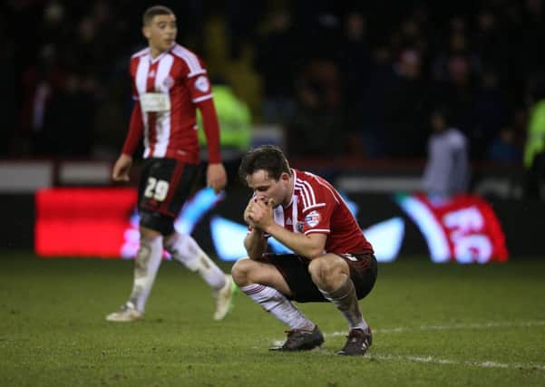 HIGHS AND LOWS: Sheffield Uniteds Jose Baxter shows his dismay, with two-goal hero Che Adams looking on behind, after the Blades were denied by Premier League Tottenham Hotspur last night. Picture: Martyn Harrison.
