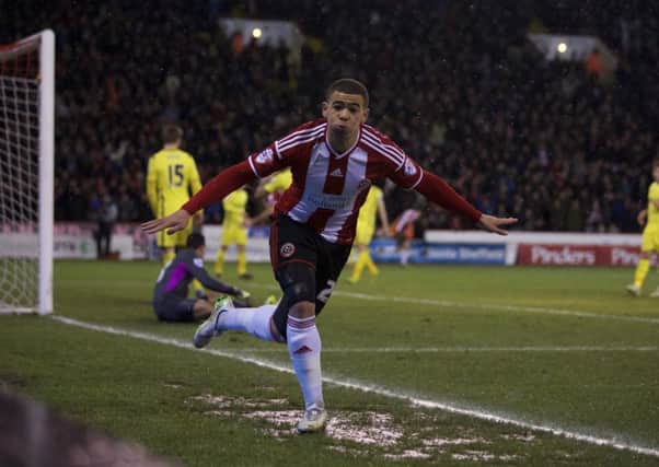 STAR: 
Sheffield United's Che Adams wheels away to celebrate his first goal against Tottenham. Picture: Martyn Harrison.