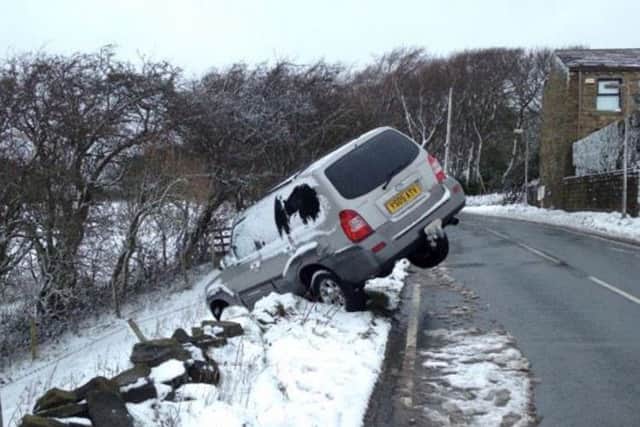 A vehicle off the road after heavy snowfall at Emley. PIC: Ross Parry