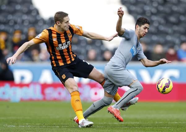 Hull City's Michael Dawson and Newcastle United's Ayoze Perez (right) battle for the ball.