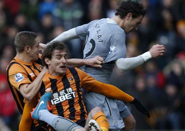 Newcastle United's Michael Williamson and Daryl Janmatt stop Hull City's Michael Dawson and Nikica Jelavic during the Barclays Premier League match at the KC Stadium, Hull.